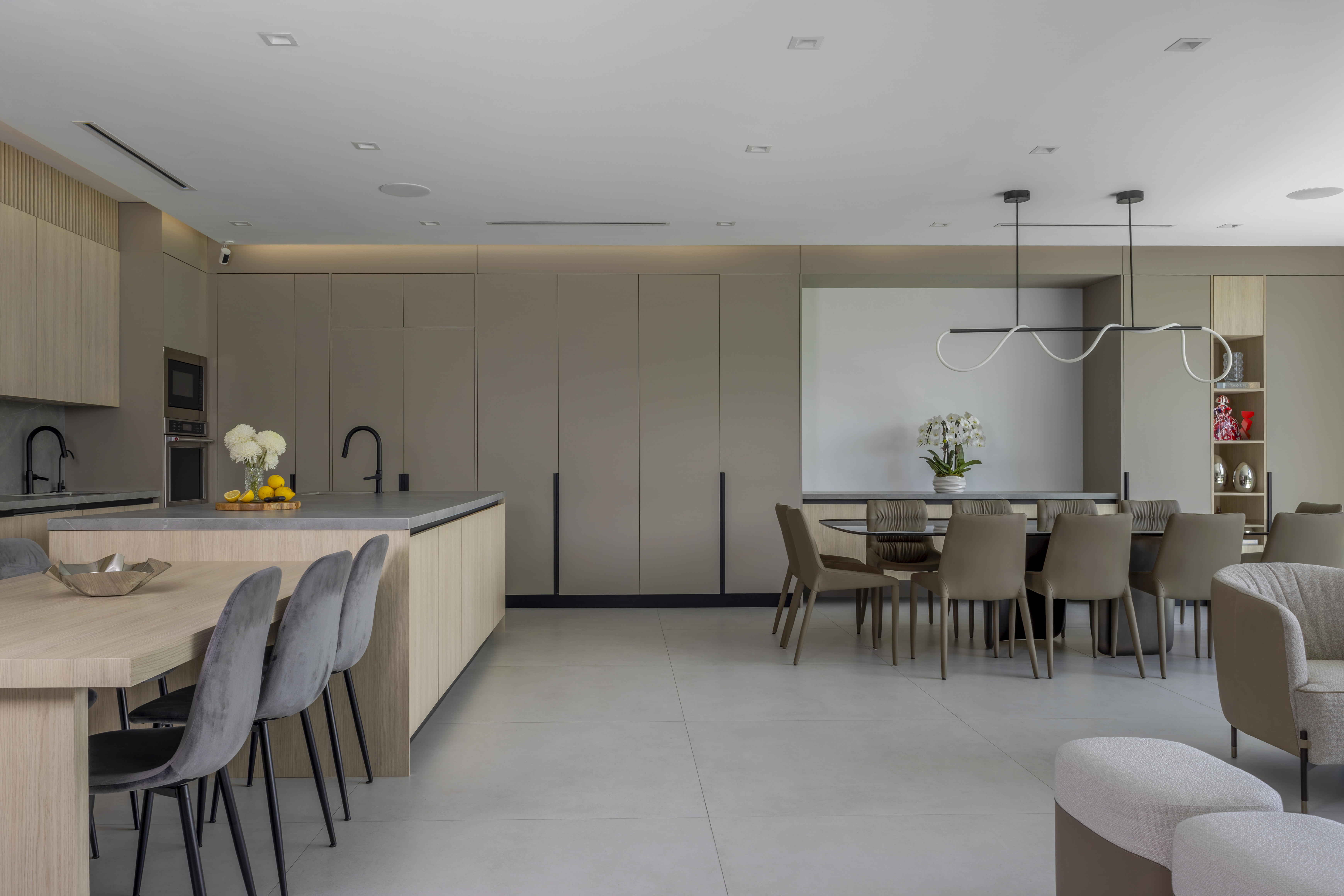 Kitchen — island with bar seating and dining beyond