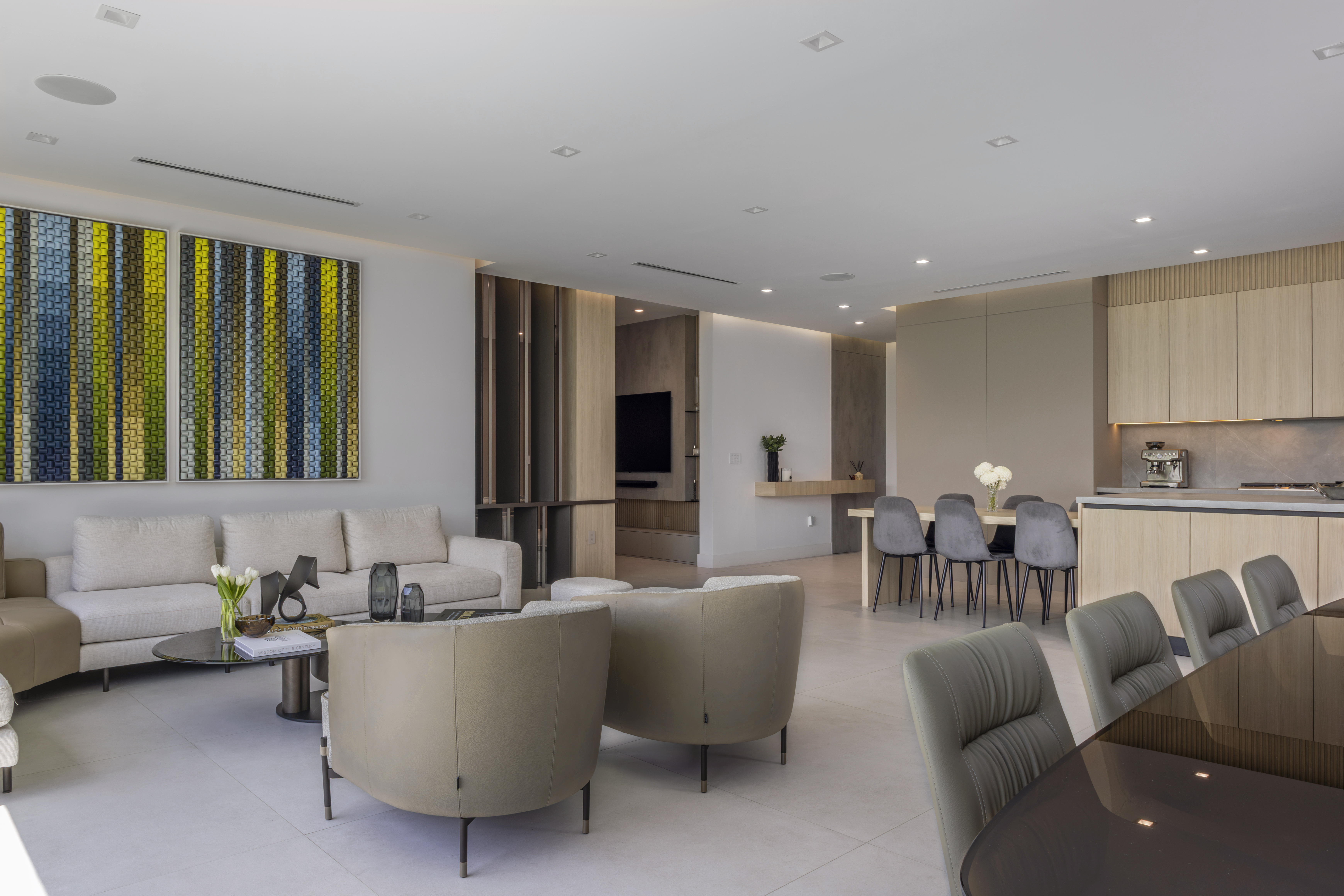 Open plan — living room with statement art and kitchen beyond