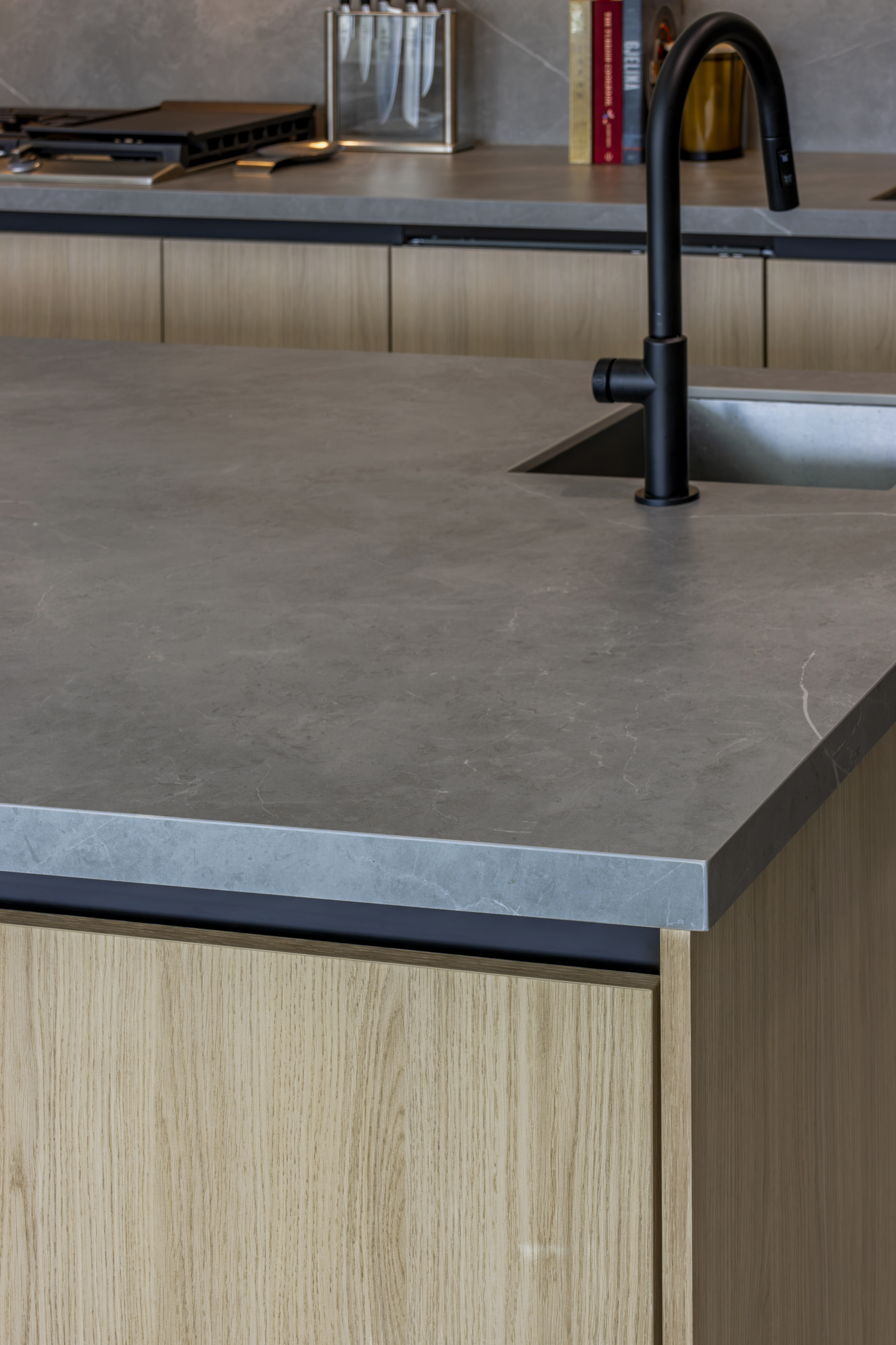 Kitchen — island countertop and black faucet detail