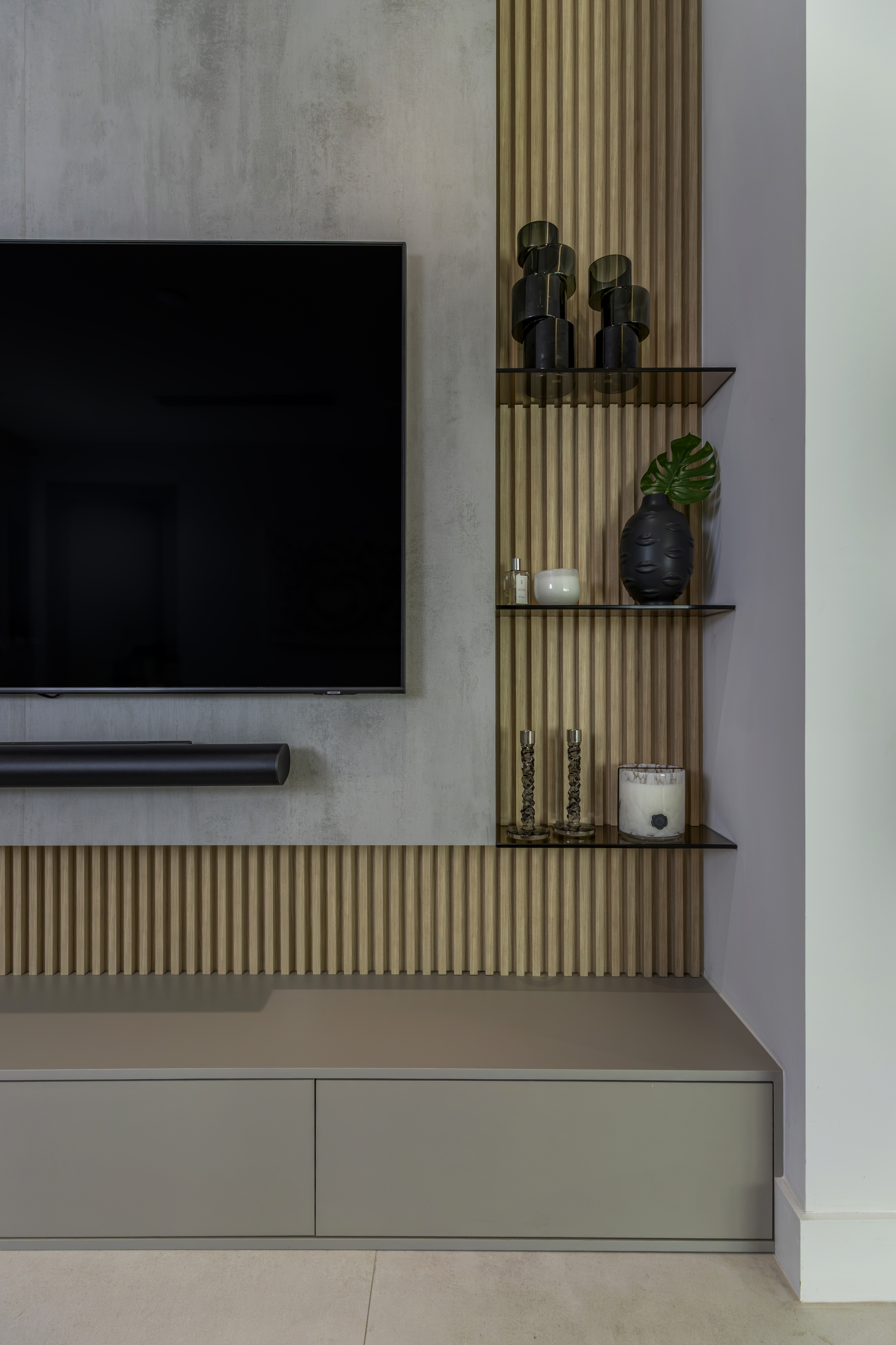 Family room — TV wall with fluted oak panels and glass shelves