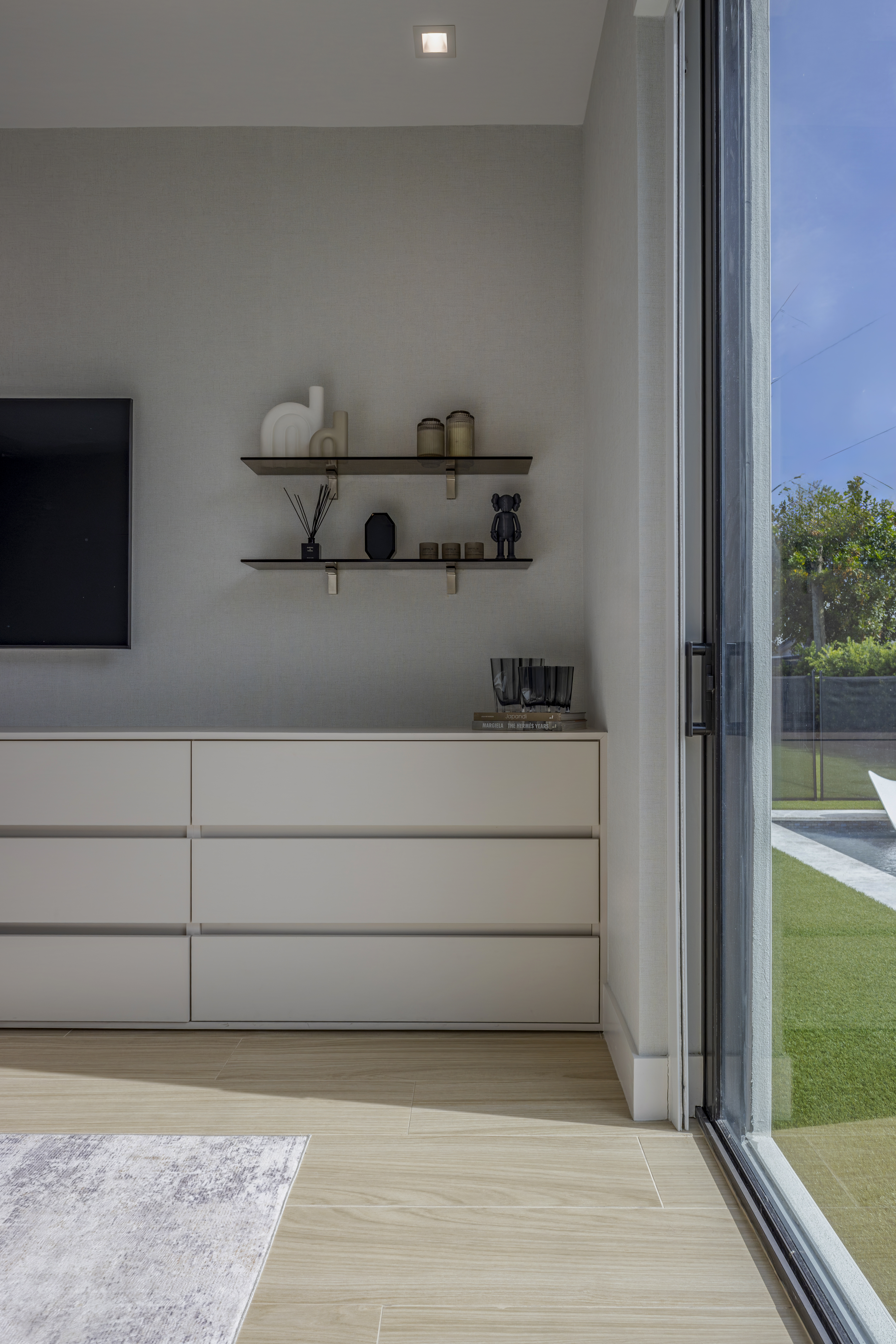 Bedroom — dresser and shelving with pool view