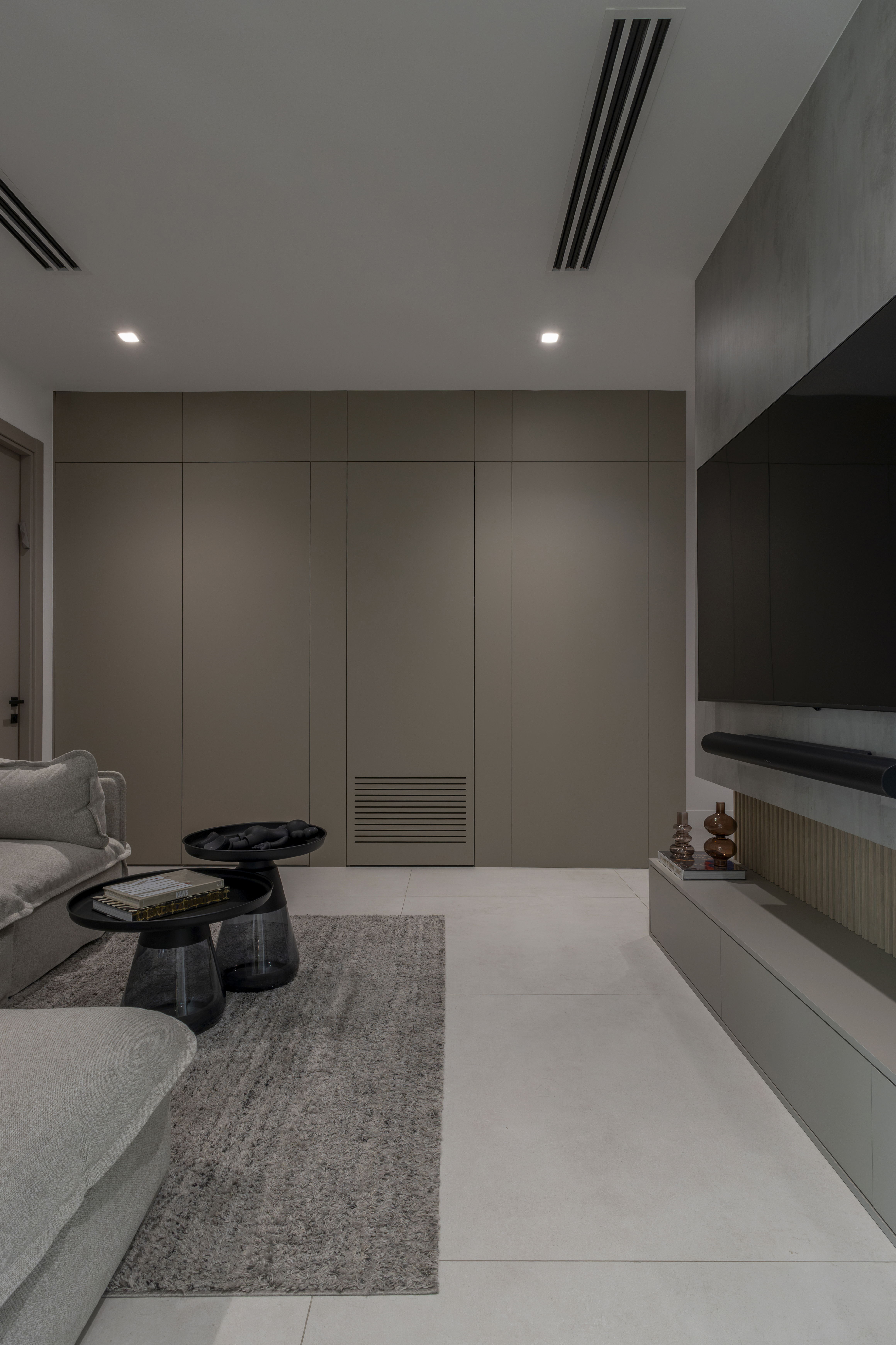 Family room — sofa, coffee tables and taupe panel wall