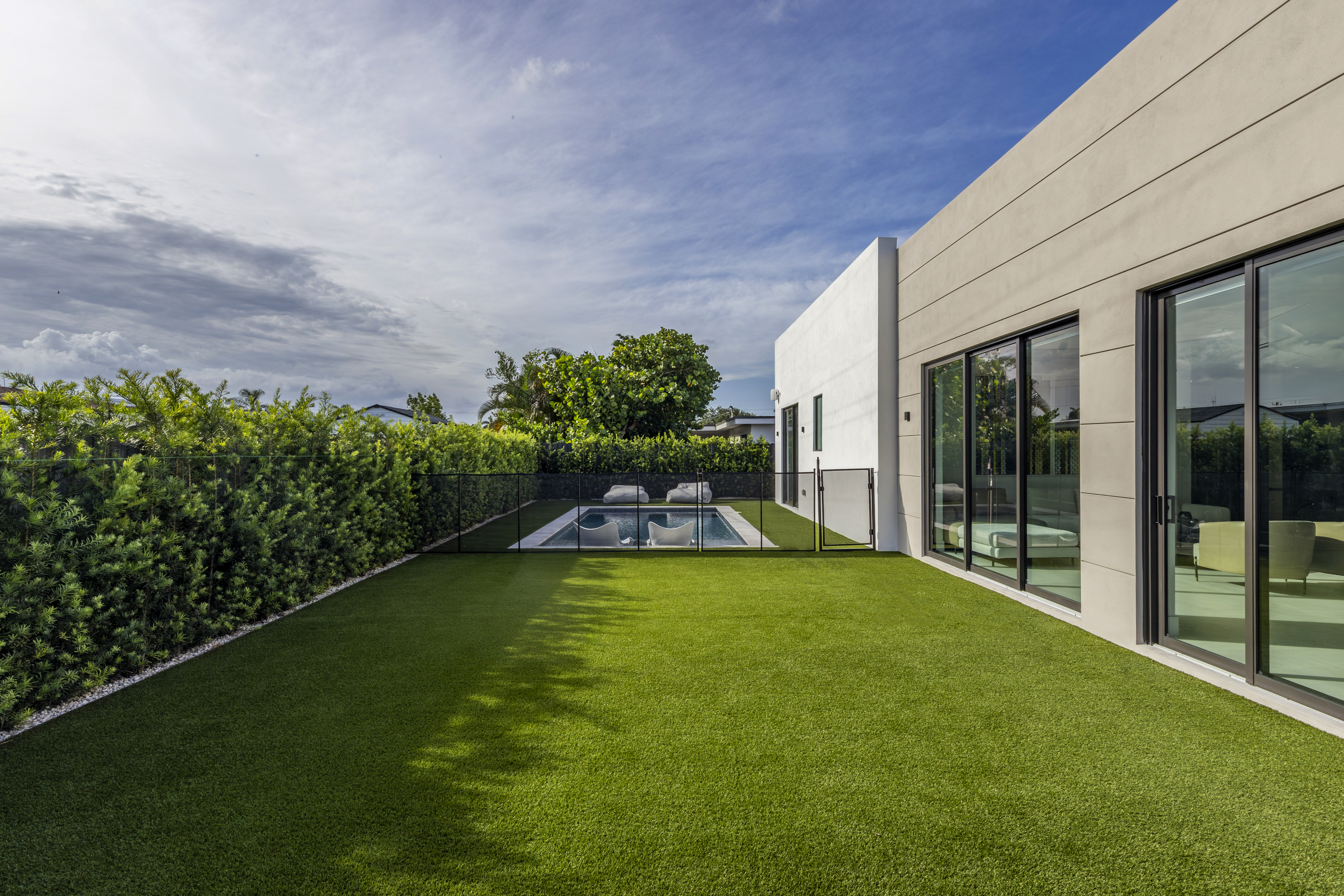 Exterior — backyard lawn with pool beyond