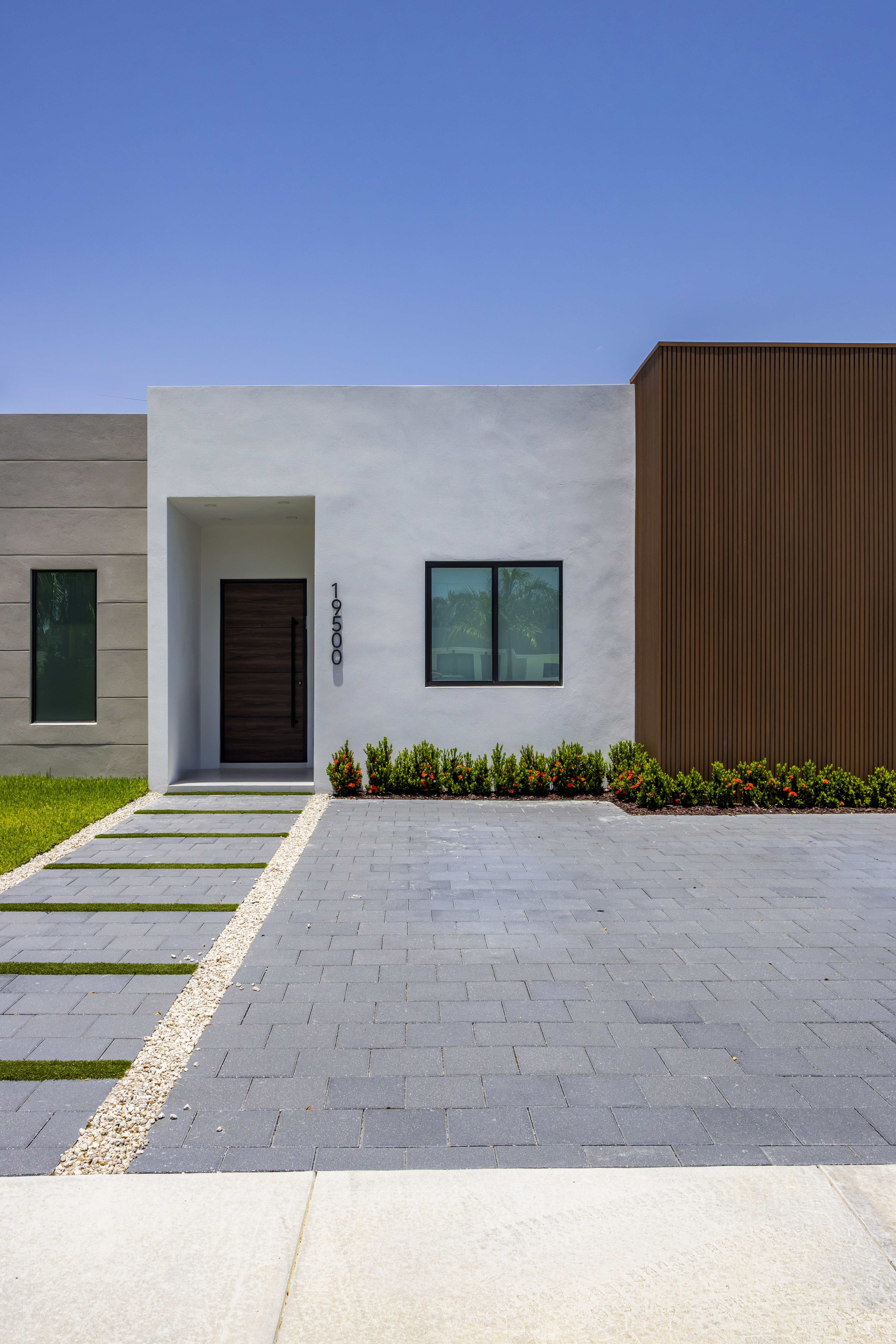 Exterior — front entrance with address and pivot door