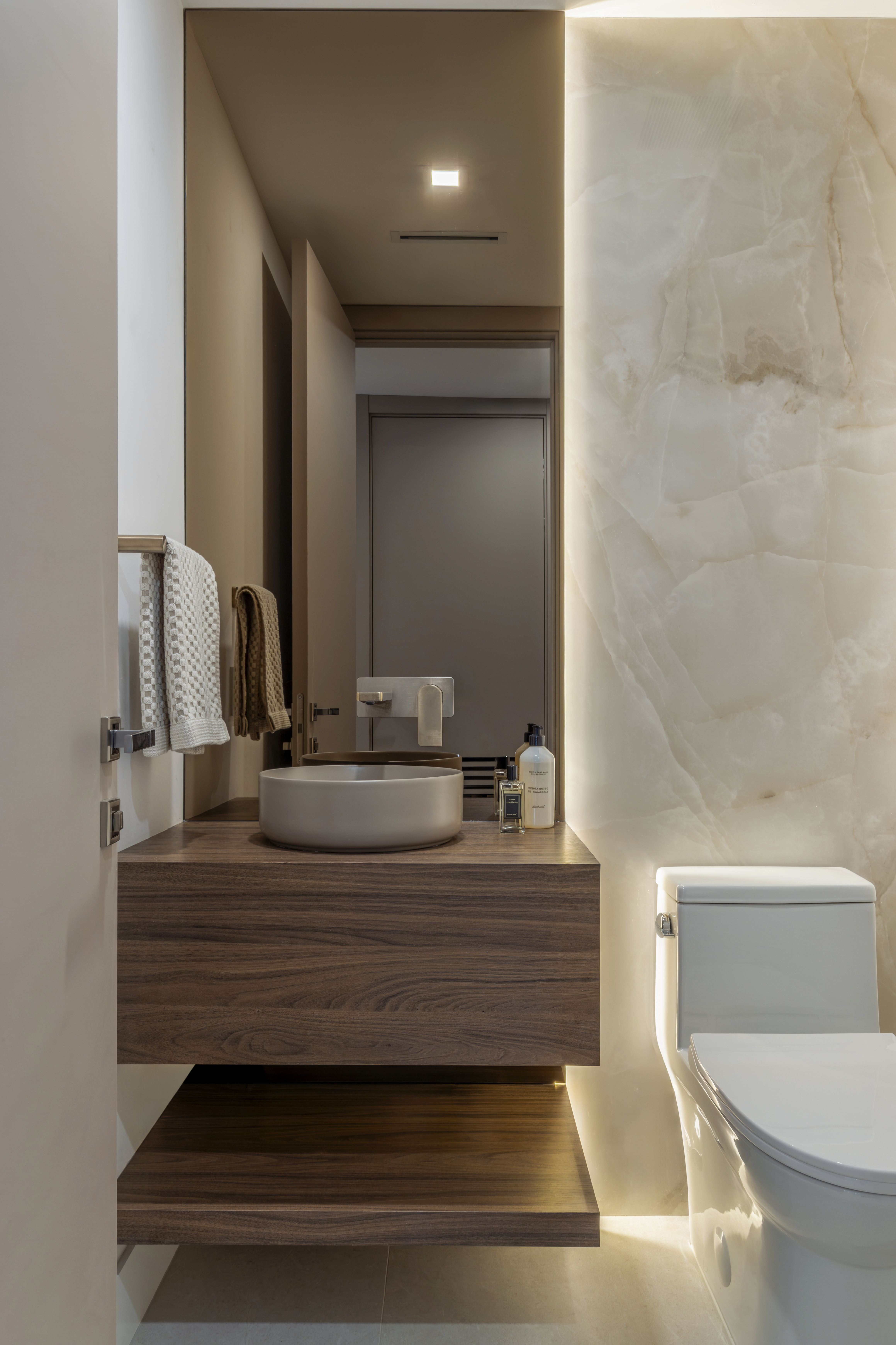 Powder room with backlit stone wall