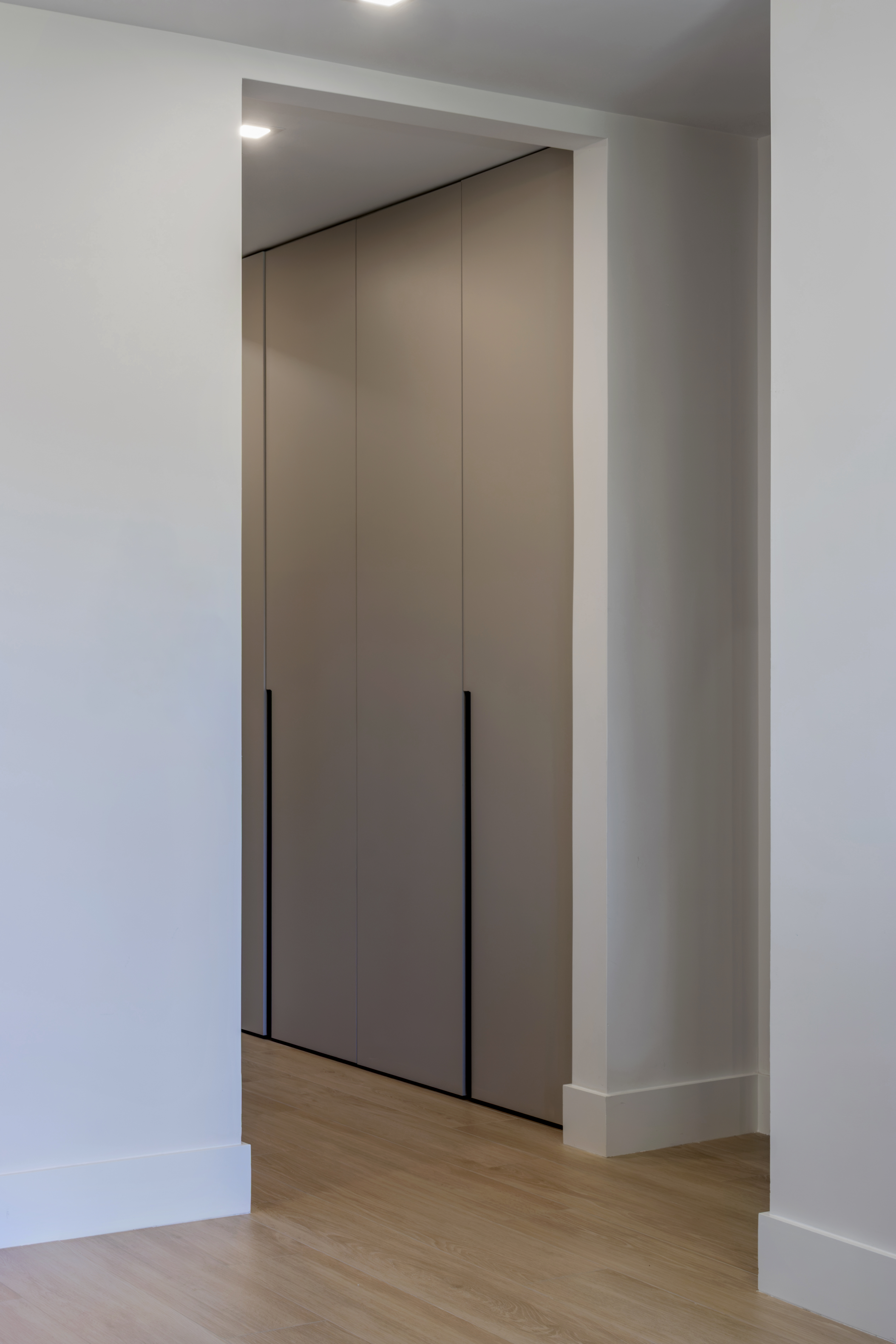 Walk-in wardrobe with taupe panel doors
