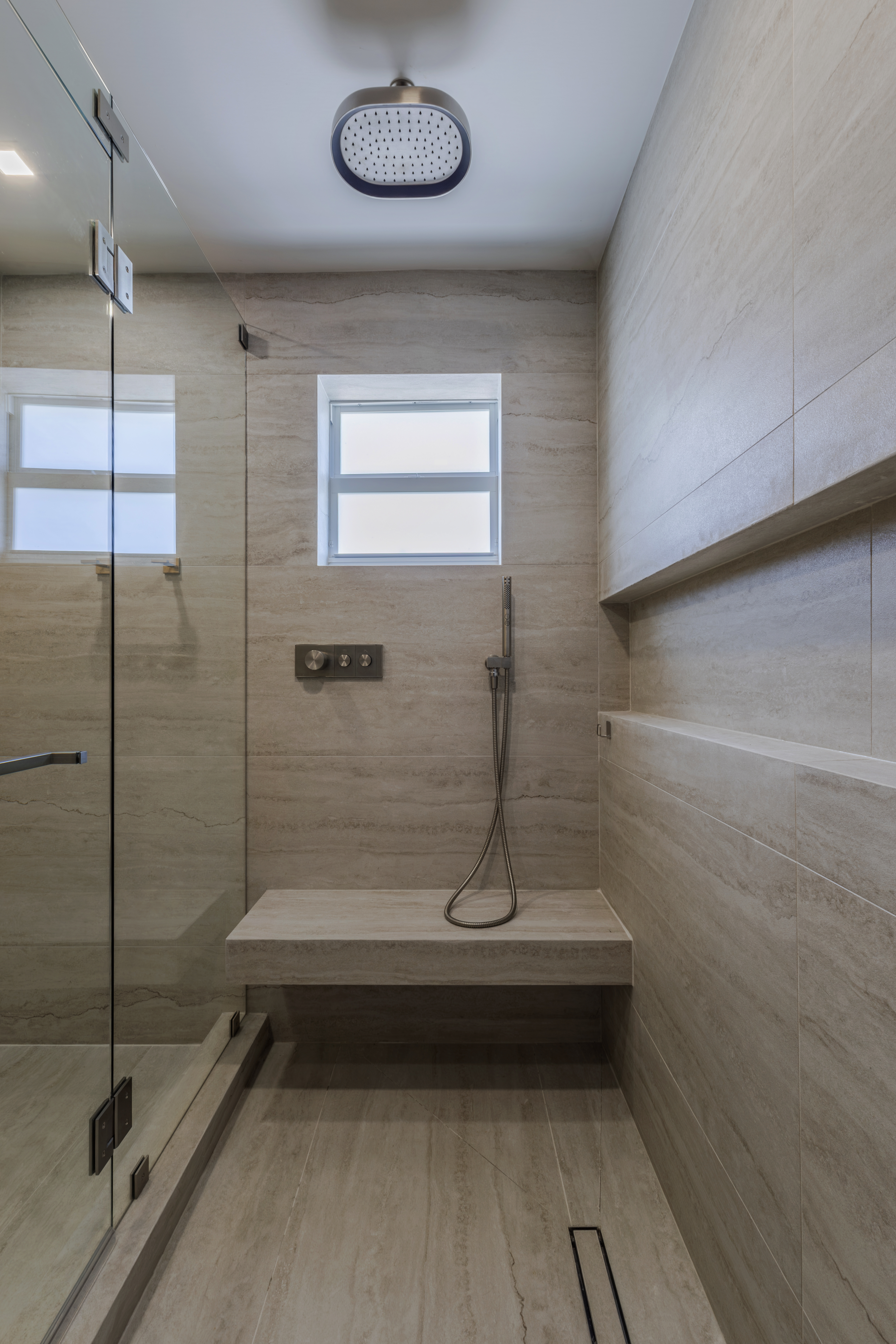 Master shower — rain head and stone bench