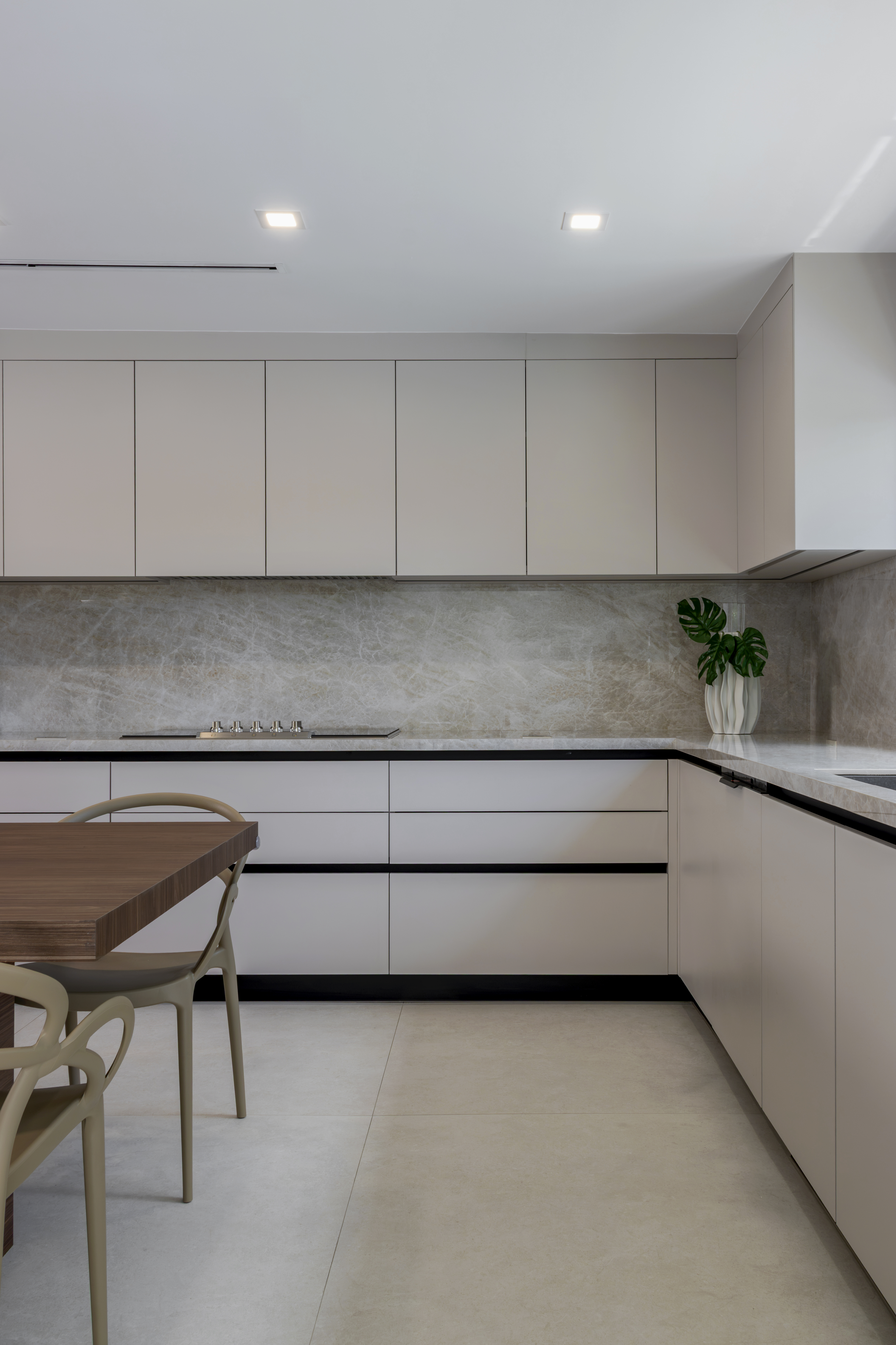 Kitchen cabinetry and stone backsplash