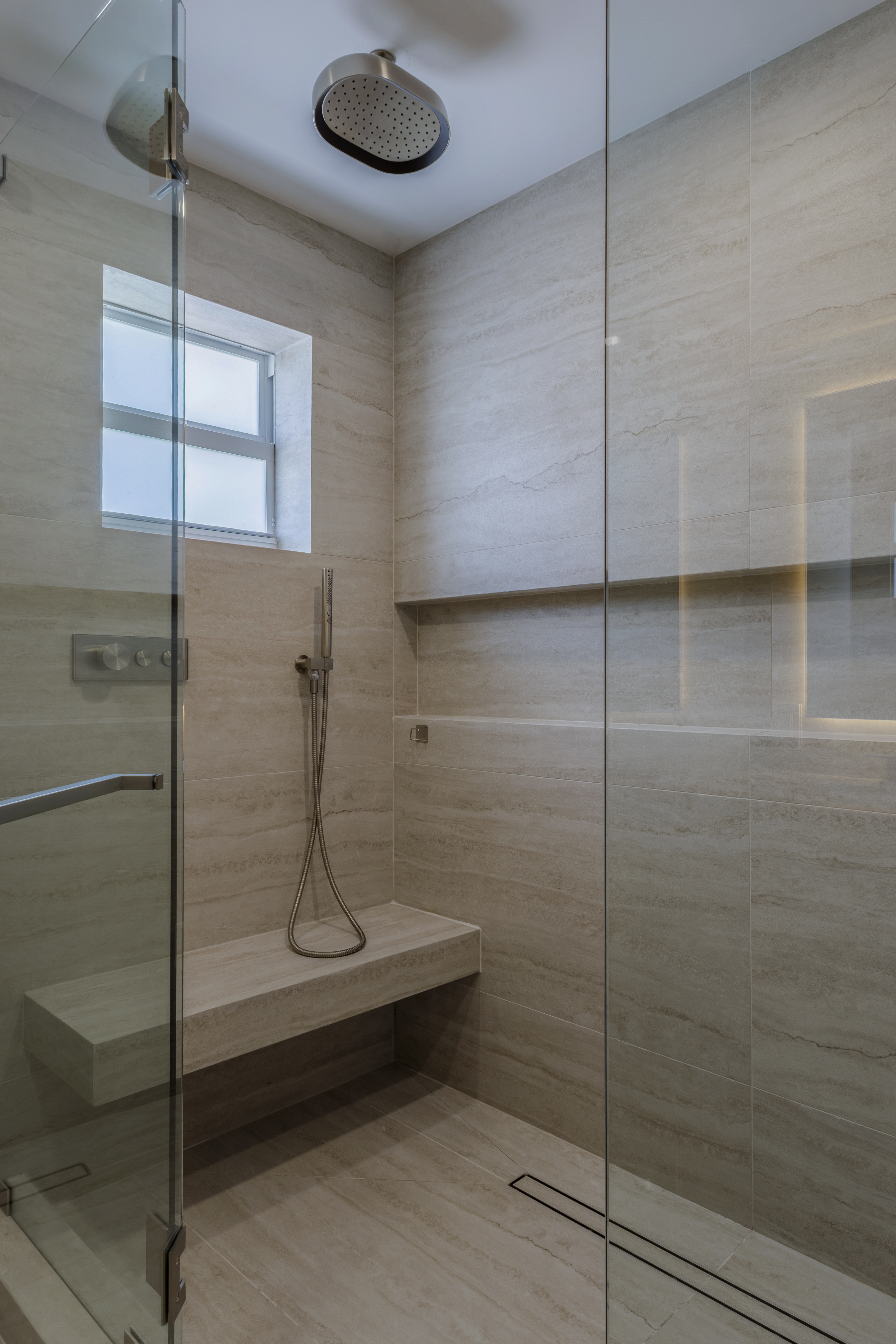 Master shower — travertine walls and bench