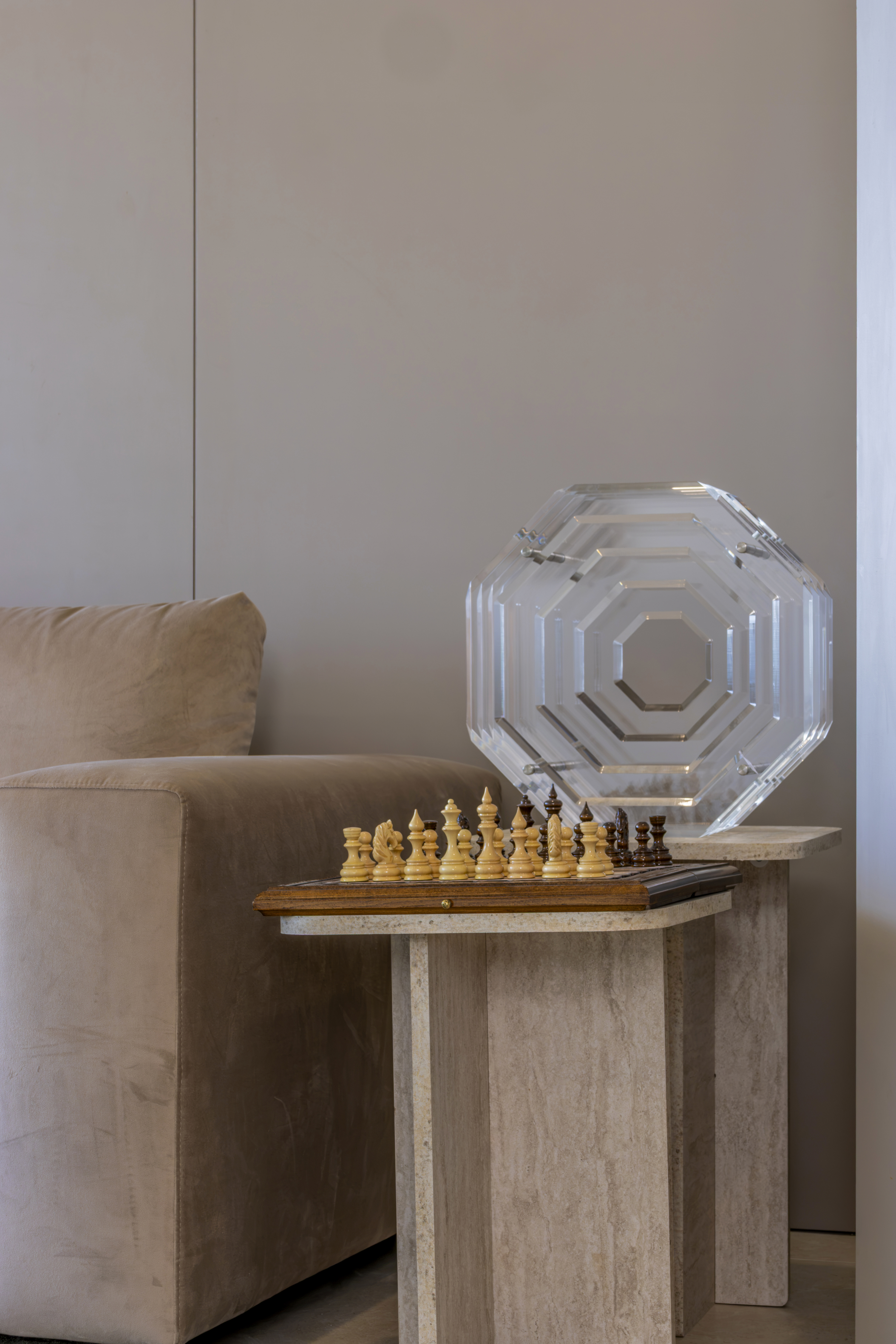 Side table with chess set and octagonal crystal sculpture