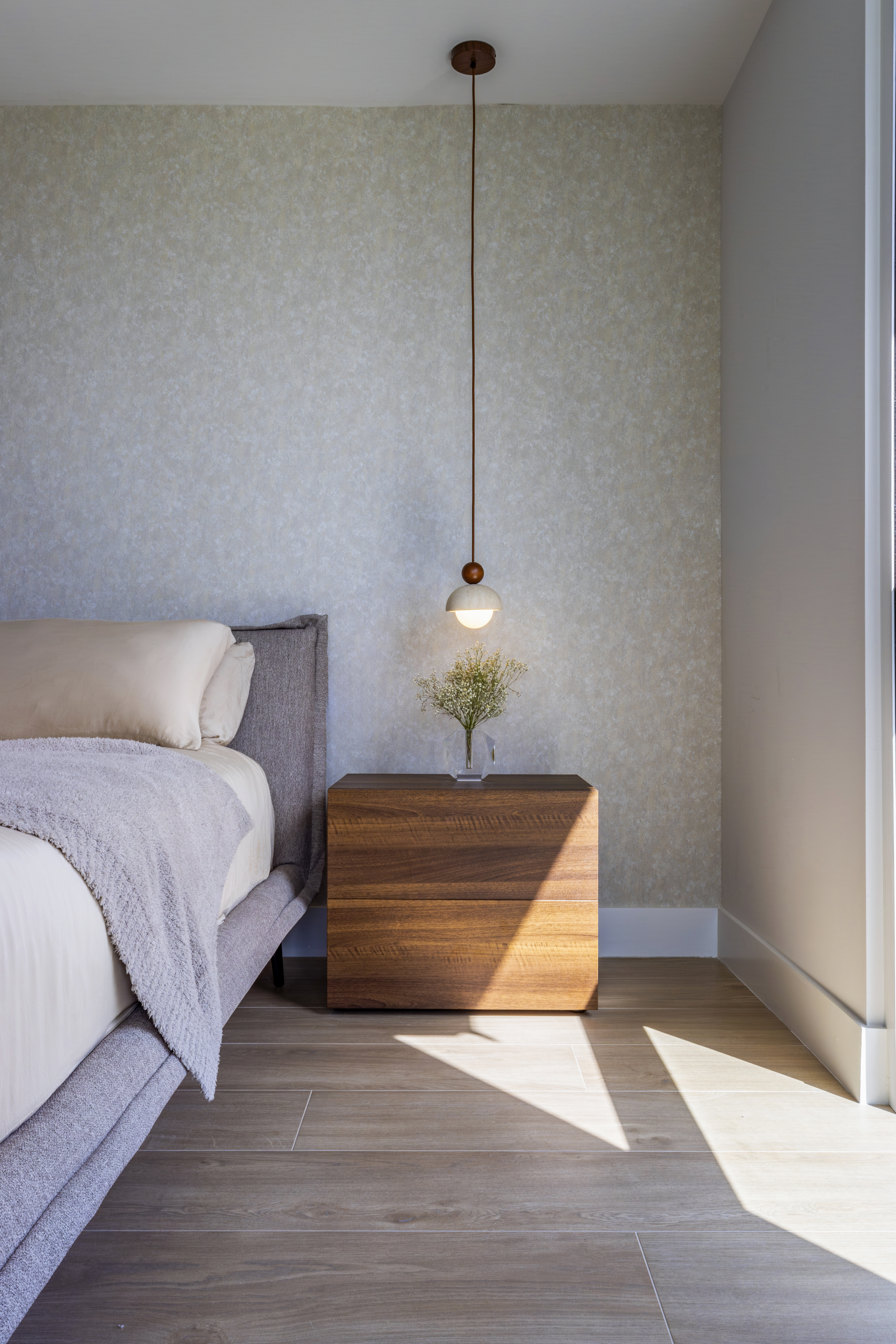 Nightstand — pendant light and baby's breath in glass vase
