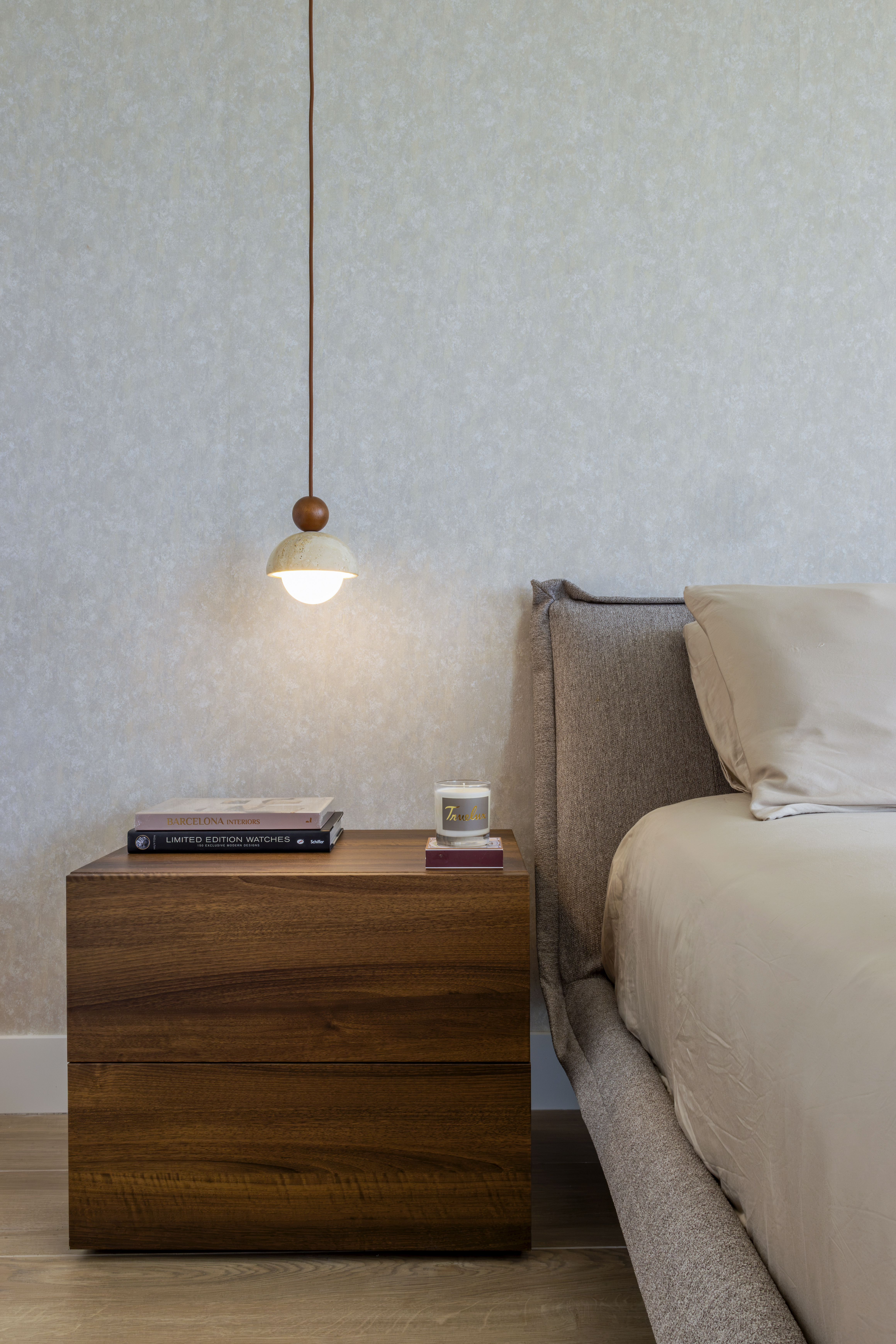 Nightstand — walnut dresser with design books and candle
