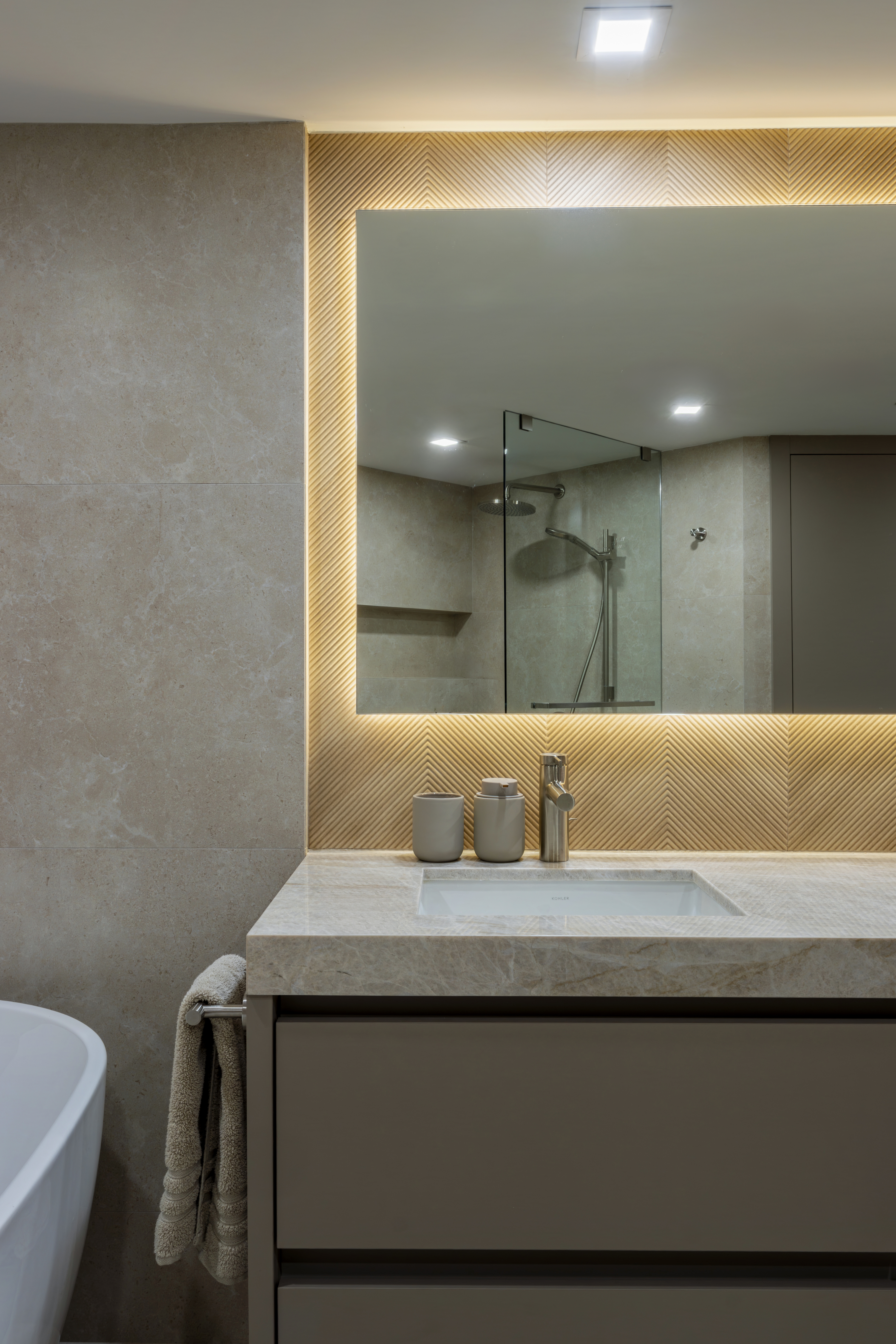 Vanity with backlit chevron tile mirror