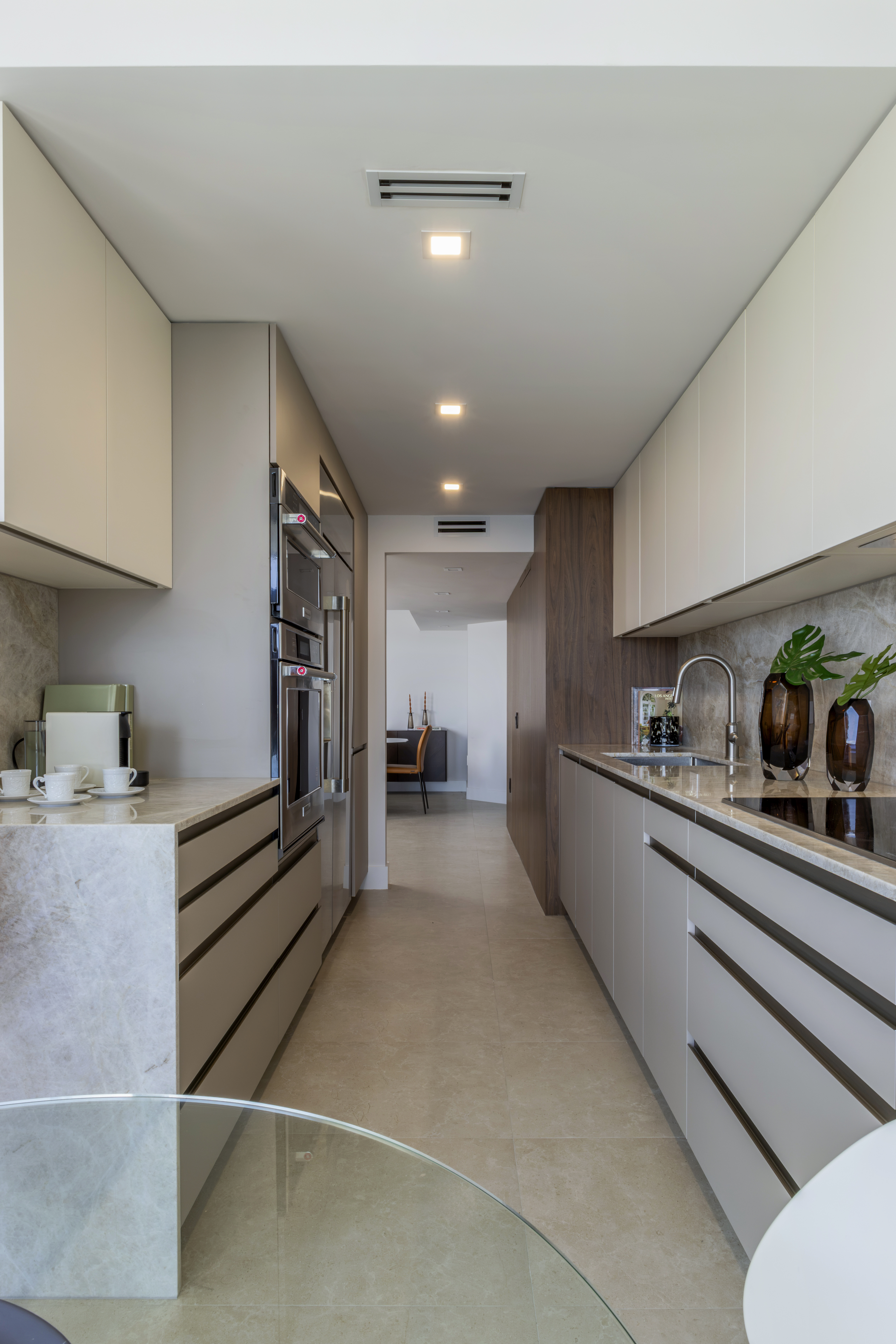 Kitchen — full galley view with appliance tower and marble backsplash