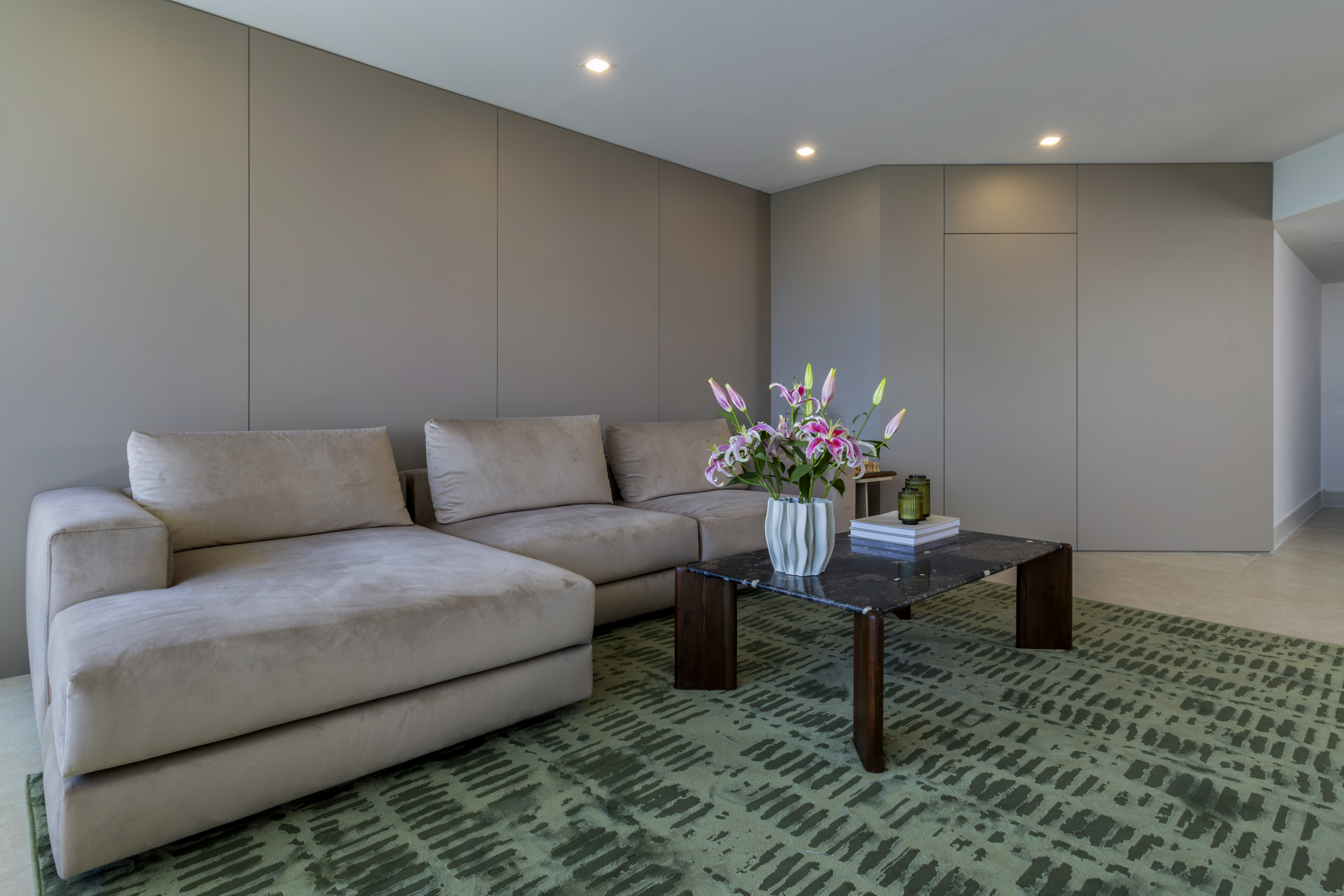 Sectional sofa with lily arrangement and coffee table